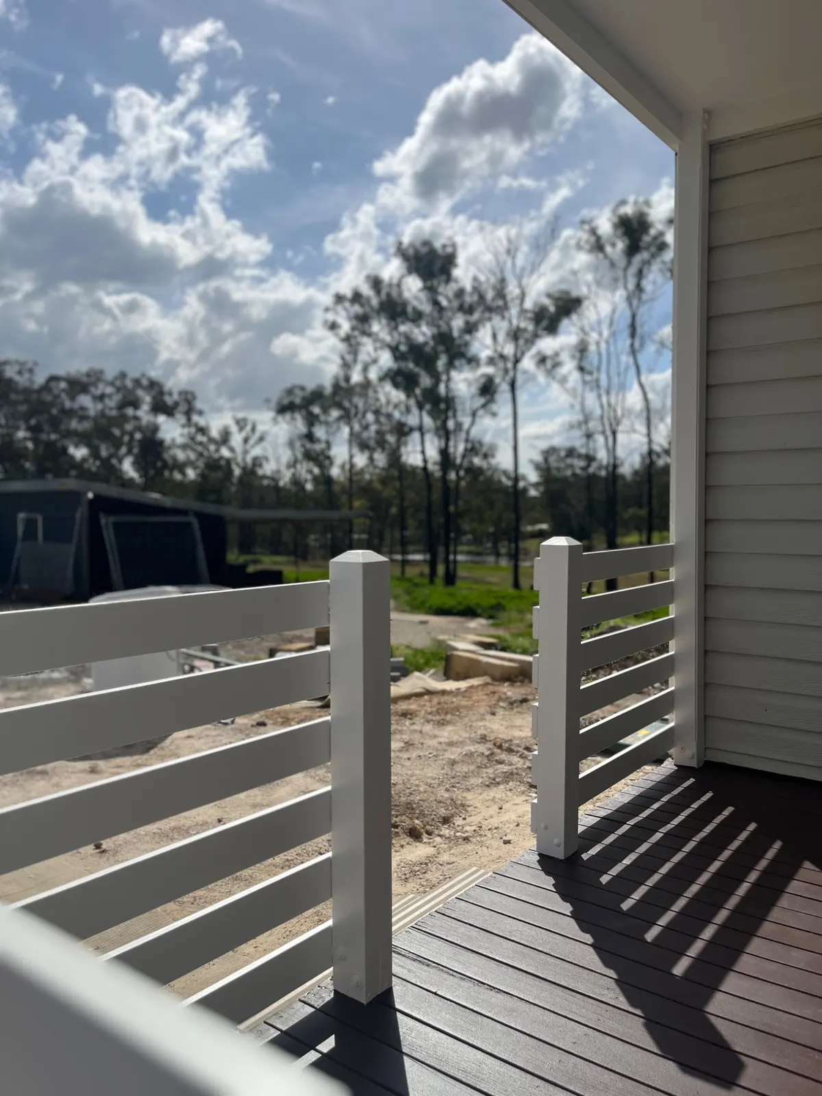 Freshly painted deck and white railing in The Gables